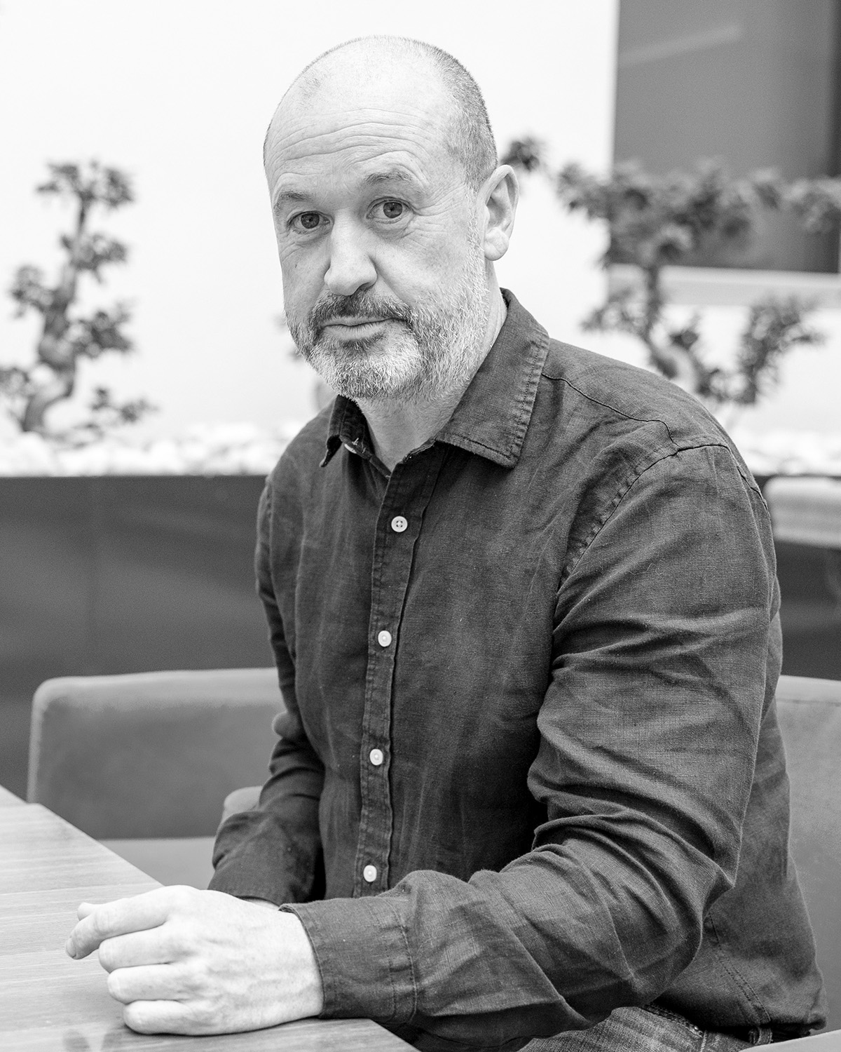 Portrait of Mike Bracken, seated at a table, taken by Paul Clarke